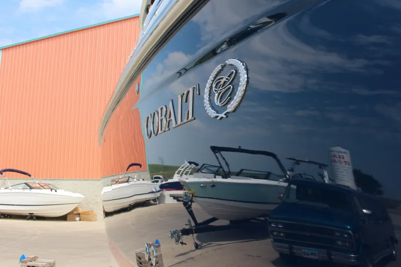 Slide: The Image of 2017 Cobalt R35 boat reflecting other boats and a building in a marina setting. - 45
