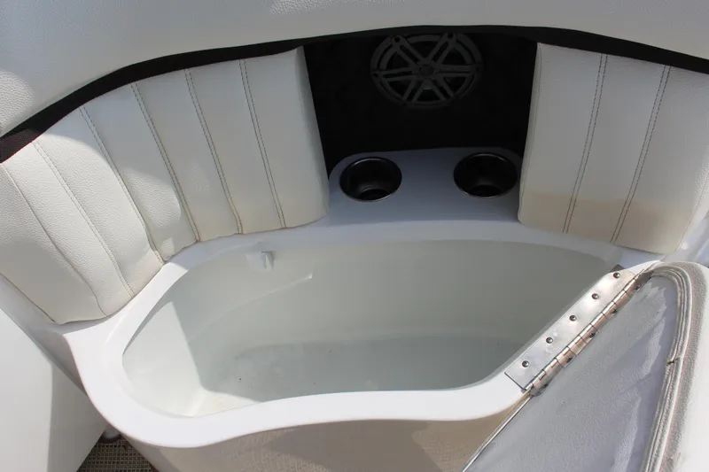 Slide: The Image of 2017 Cobalt R35 boat interior with white seating and built-in cup holders. - 52