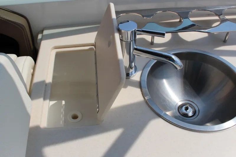 Slide: The Image of 2017 Cobalt R35 boat sink and faucet with cup holders. - 59