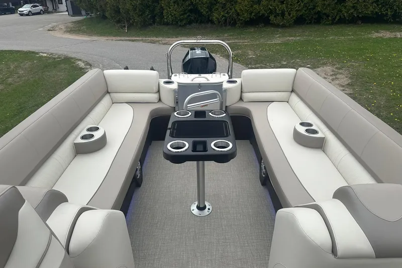 Slide: The Image of 2025 Tahoe 2585 pontoon boat interior with spacious seating and cup holders. - 10