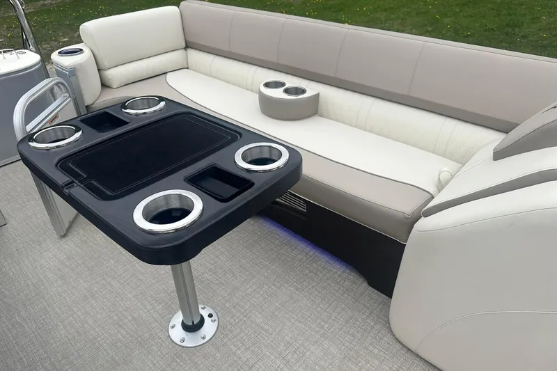 Slide: The Image of Luxurious seating area on 2025 Tahoe 2585 boat with table and cup holders. - 11