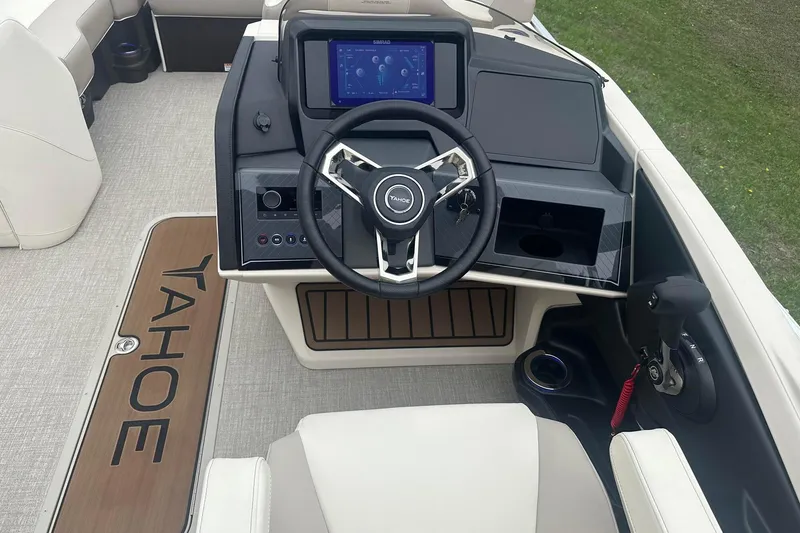 Slide: The Image of 2025 Tahoe 2585 boat dashboard with steering wheel, touchscreen, and control panel. - 13