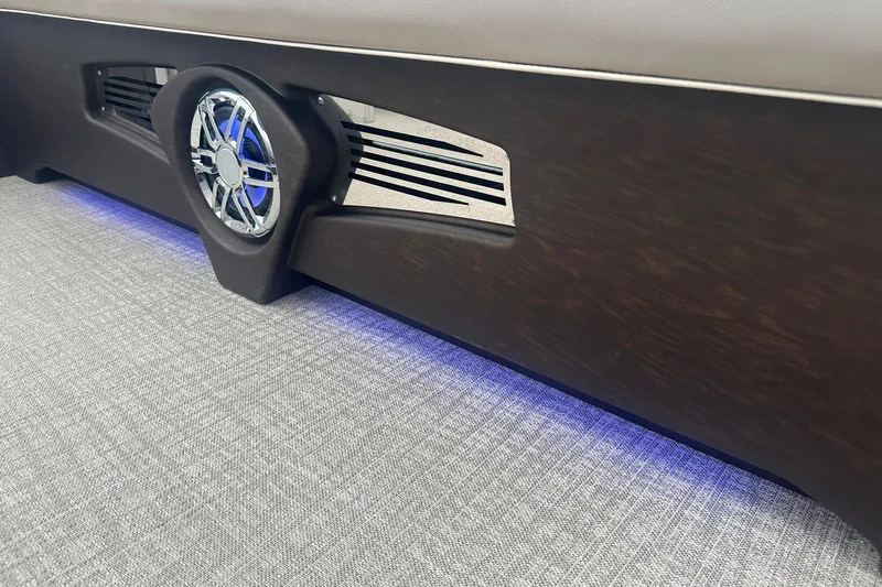Slide: The Image of 2025 Tahoe 2585 interior detail with sleek speaker and ambient blue lighting. - 18