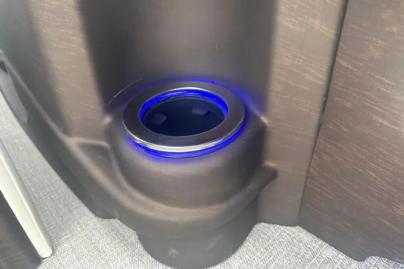 Slide: The Image of Illuminated cup holder in 2025 Tahoe 2585 boat interior. - 19