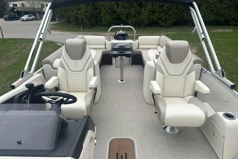 Slide: The Image of 2025 Tahoe 2585 boat interior with luxurious seating and modern steering console. - 22