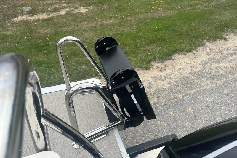 Slide: The Image of Stainless steel ladder on 2025 Tahoe 2585 boat, set against grassy background. - 25