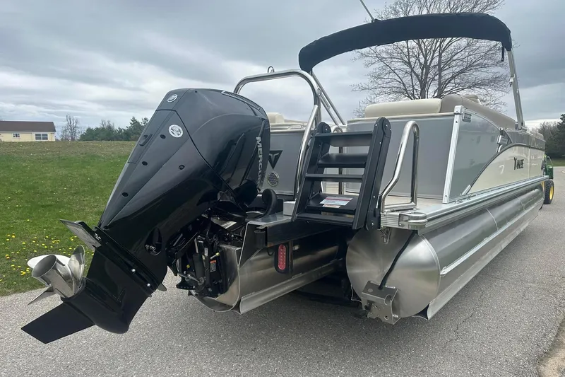 Slide: The Image of 2025 Tahoe 2585 pontoon boat with powerful outboard motor on a trailer. - 5