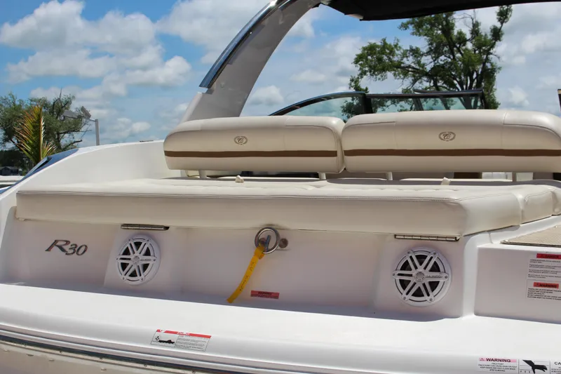 Slide: The Image of 2016 Cobalt R30 boat with white seating and speakers, under a blue sky. - 11