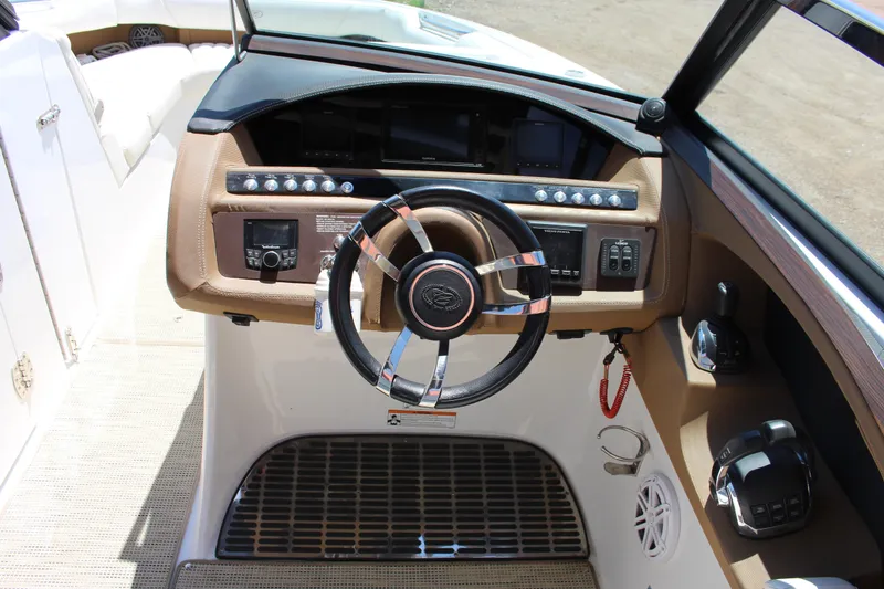 Slide: The Image of 2016 Cobalt R30 boat dashboard with steering wheel and control panel. - 4