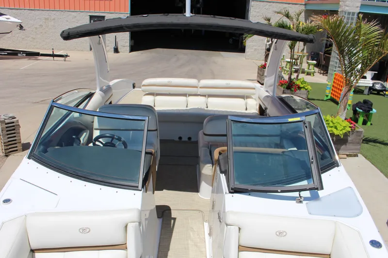 Slide: The Image of 2016 Cobalt R30 boat with open seating and canopy, displayed outdoors. - 9