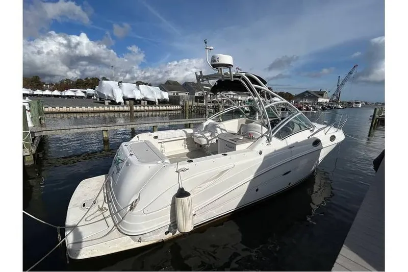 The Image of 2007 Sea Ray 270 Amberjack boat docked at marina under clear sky. - 1