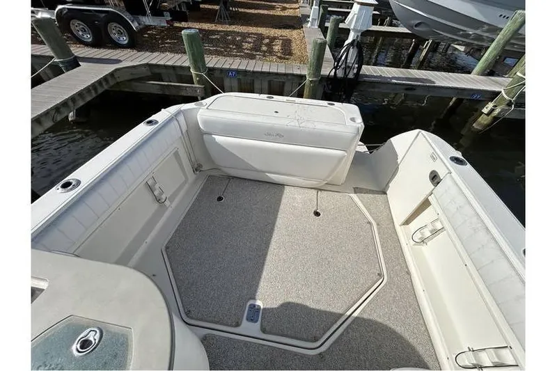Slide: The Image of 2007 Sea Ray 270 Amberjack boat interior with spacious deck and seating at dock. - 10