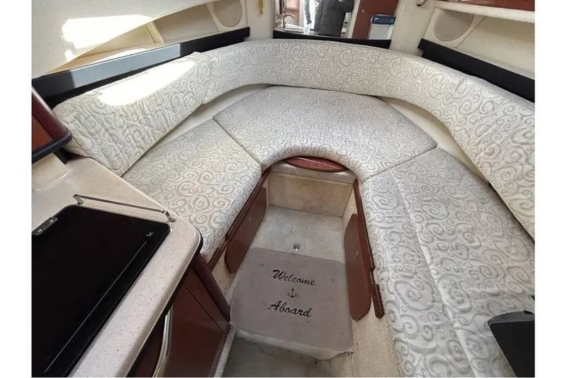 Slide: The Image of 2007 Sea Ray 270 Amberjack cabin interior with patterned seating and "Welcome Aboard" mat. - 13