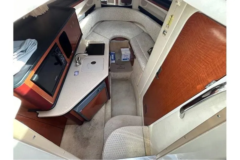 Slide: The Image of 2007 Sea Ray 270 Amberjack cabin interior with kitchenette and seating area. - 16