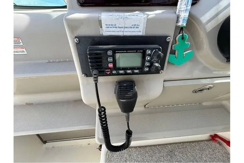 Slide: The Image of VHF radio on 2007 Sea Ray 270 Amberjack boat dashboard with anchor keychain. - 17