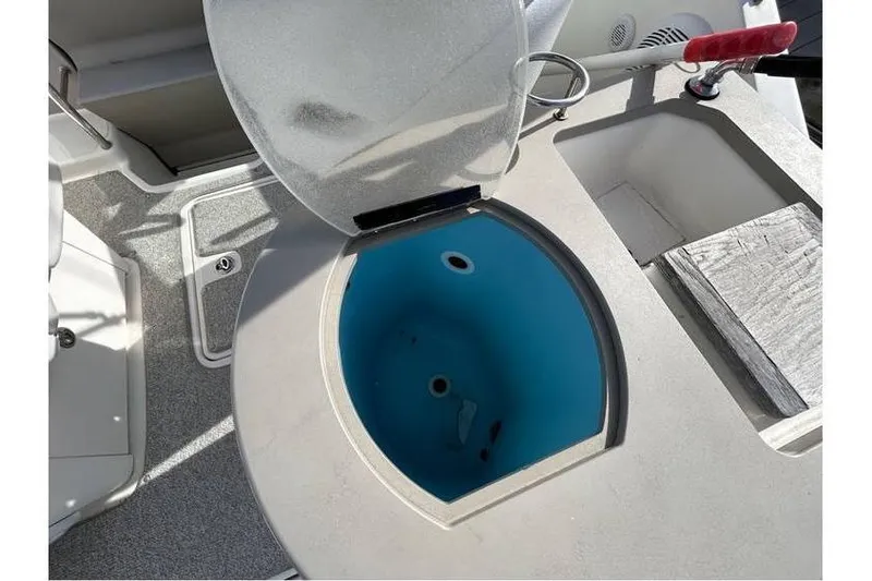 Slide: The Image of Open hatch on 2007 Sea Ray 270 Amberjack boat, revealing blue interior compartment. - 19
