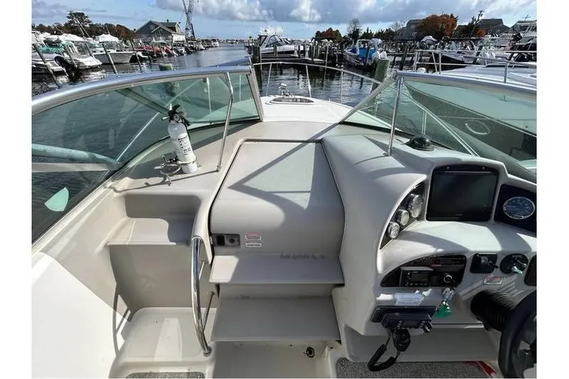 Slide: The Image of 2007 Sea Ray 270 Amberjack boat cockpit with steering controls and marina view. - 4