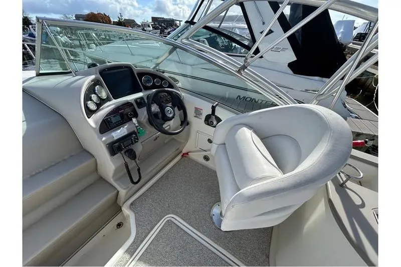 Slide: The Image of 2007 Sea Ray 270 Amberjack helm with steering wheel and control panel. - 5