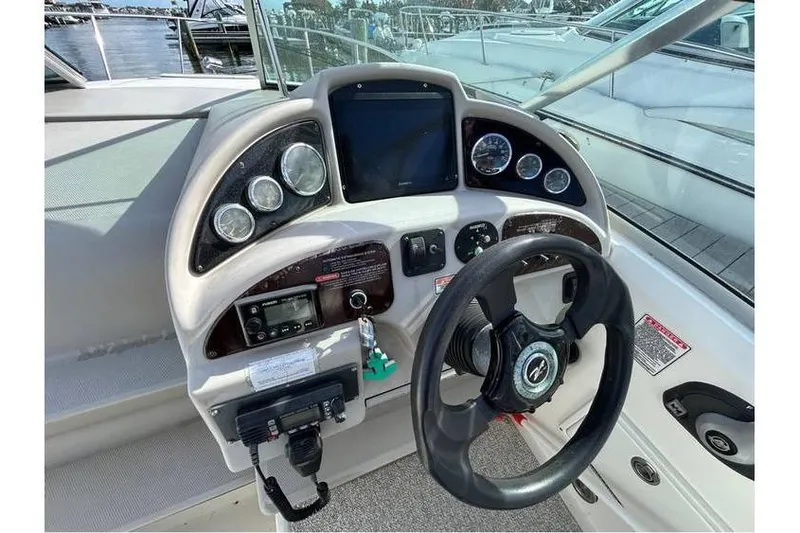 Slide: The Image of 2007 Sea Ray 270 Amberjack helm with steering wheel, gauges, and control panel. - 6