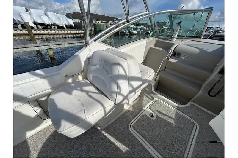 Slide: The Image of 2007 Sea Ray 270 Amberjack boat interior with white seating and helm. - 9