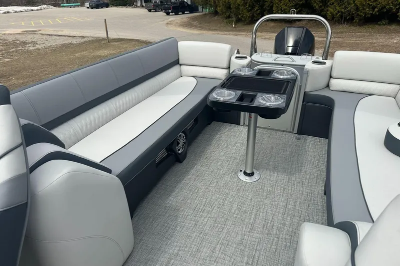 Slide: The Image of 2025 Tahoe 2585 boat interior with gray seating and a central table. - 14