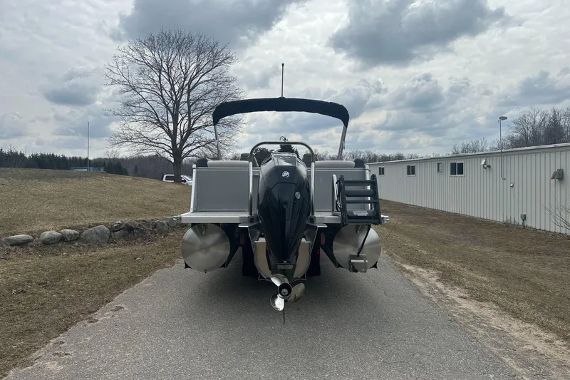Slide: The Image of 2025 Tahoe 2585 boat on a paved path under cloudy skies. - 3