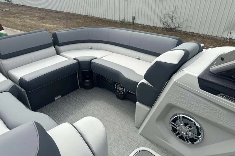 Slide: The Image of 2025 Tahoe 2585 boat interior with gray and white seating, featuring modern design and speaker system. - 9