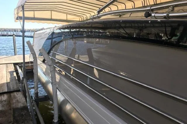 The Image of 2015 Marker One boat docked under canopy on a sunny day. - 1