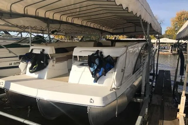 Slide: The Image of 2015 Marker One boat docked under canopy with life jackets. - 3