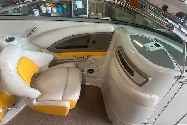 Slide: The Image of 2015 Crownline E6 boat interior with white and yellow seating, sleek design. - 2