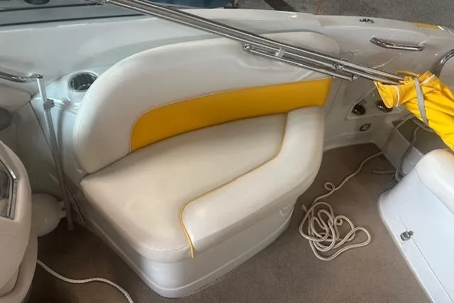 Slide: The Image of 2015 Crownline E6 boat interior with white and yellow seating, cup holder, and coiled rope. - 4