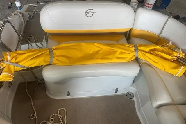 Slide: The Image of 2015 Crownline E6 boat interior with yellow cover on white seating. - 5