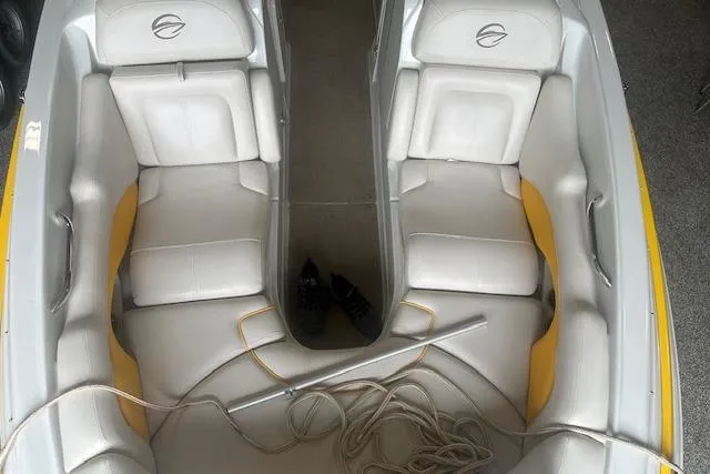 Slide: The Image of 2015 Crownline E6 boat interior with white seating and yellow accents. - 6