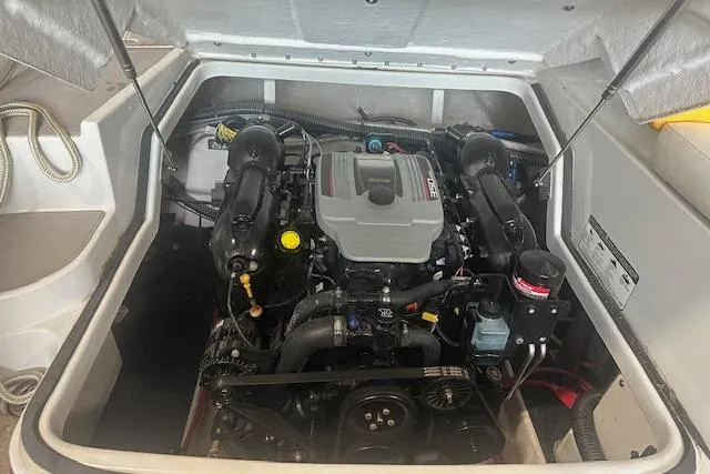 Slide: The Image of 2015 Crownline E6 boat engine compartment with visible components and wiring. - 7