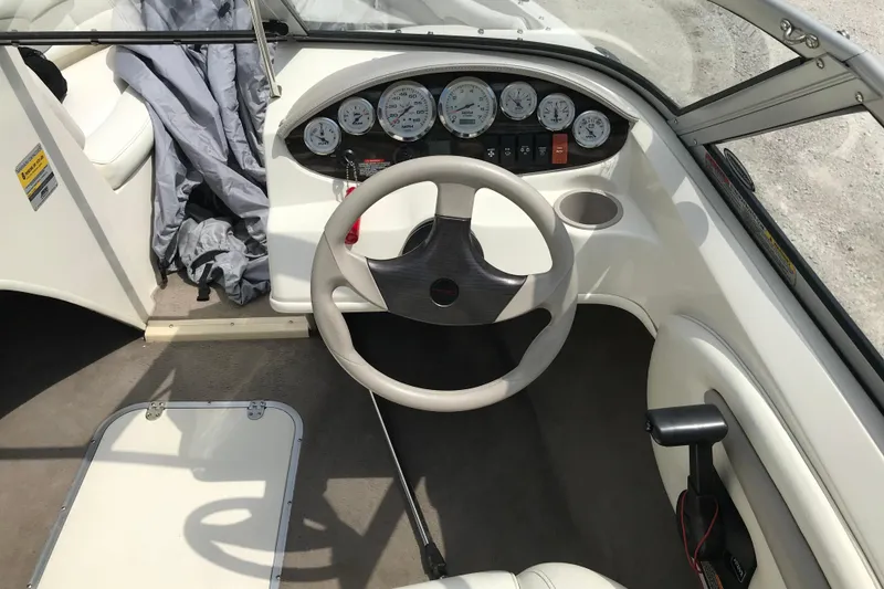 Slide: The Image of Interior of a 2005 Stingray 195 LR boat showing steering wheel and dashboard controls. - 10