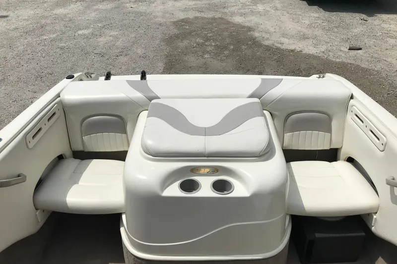 Slide: The Image of 2005 Stingray 195 LR boat interior with white seating and cup holders. - 9