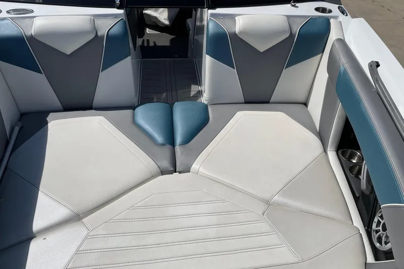 Slide: The Image of 2014 Tigé 23 boat interior with blue and gray cushioned seating. - 4