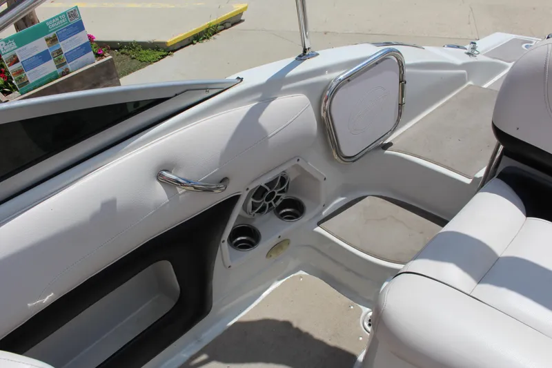 Slide: The Image of Interior of 2013 Crownline E1 boat with white seating and cup holders. - 11