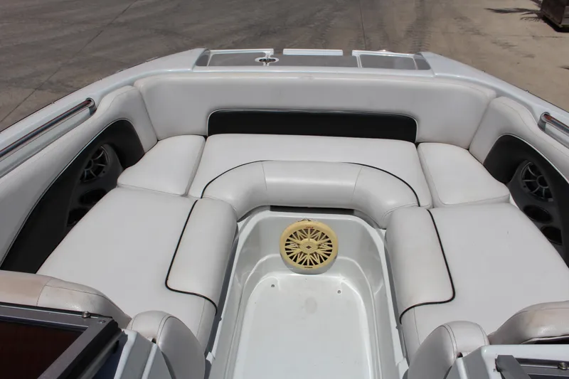 Slide: The Image of 2013 Crownline E1 boat interior with white cushioned seating and speaker system. - 12