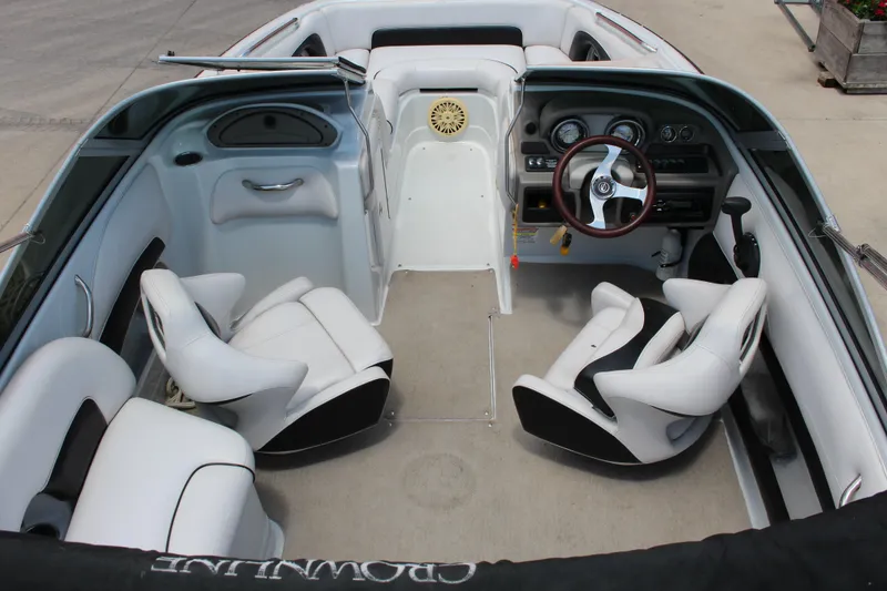 Slide: The Image of 2013 Crownline E1 boat interior with white seating and steering wheel. - 14