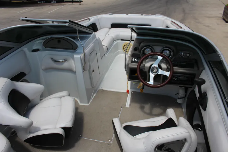 Slide: The Image of Interior of a 2013 Crownline E1 boat featuring white seating and a sleek dashboard. - 4