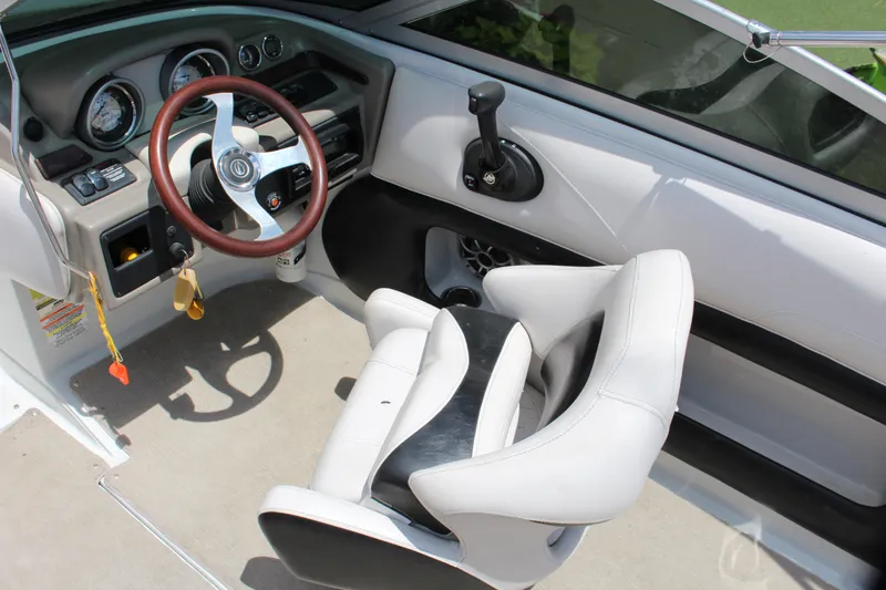 Slide: The Image of Interior of a 2013 Crownline E1 boat with steering wheel and control panel. - 6