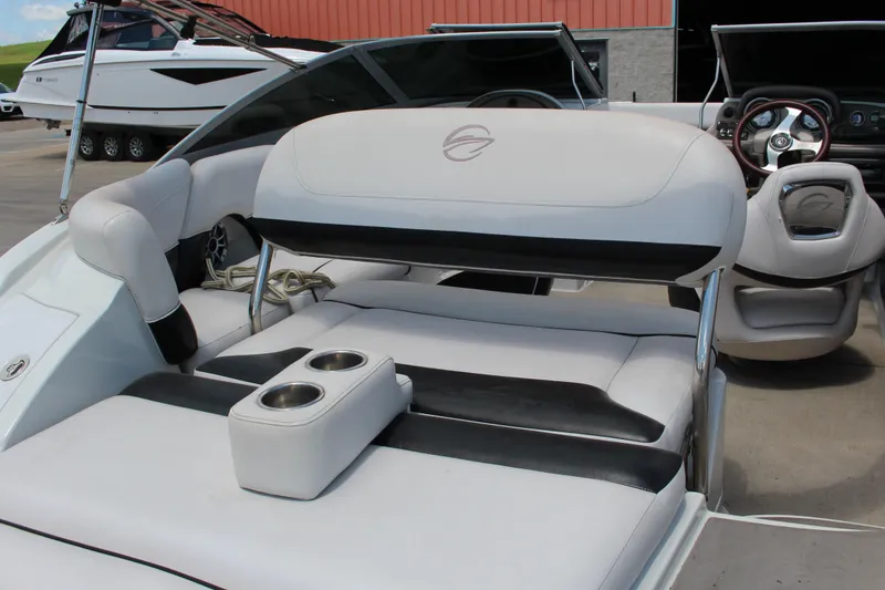 Slide: The Image of 2013 Crownline E1 boat interior with cushioned seating and cup holders. - 7