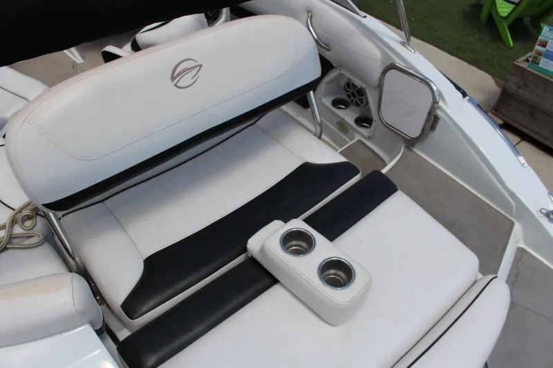 Slide: The Image of 2013 Crownline E1 boat interior with white and black seating, cup holders, and speaker. - 8