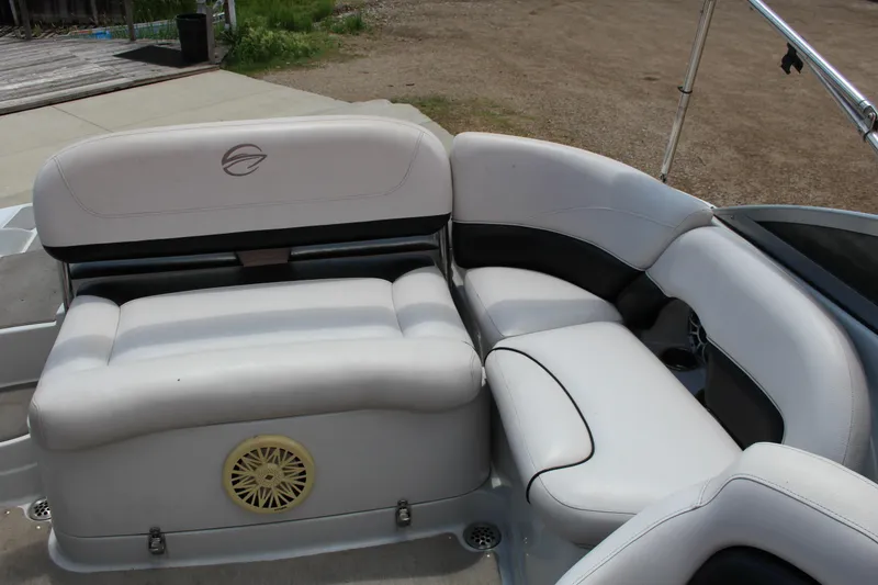 Slide: The Image of 2013 Crownline E1 boat interior with white cushioned seating and speaker. - 9