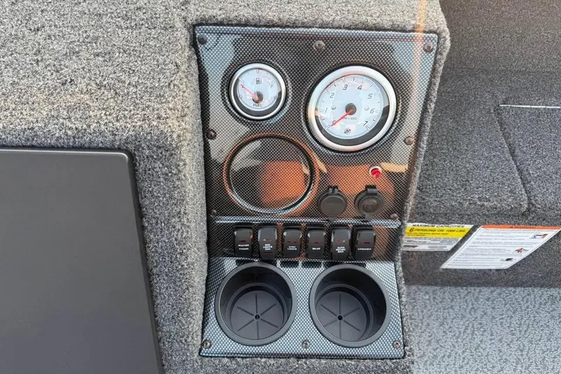 Slide: The Image of 2026 Crestliner 1850 Pro Tiller dashboard with gauges, switches, and cup holders. - 10