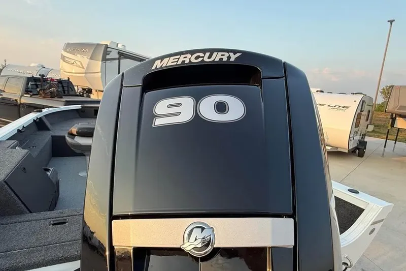 Slide: The Image of 2026 Crestliner 1850 Pro Tiller with Mercury 90 engine, parked near RVs. - 13