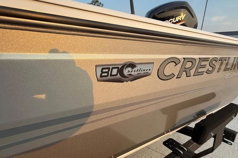 Slide: The Image of 2026 Crestliner 1850 Pro Tiller boat side view with logo and Mercury engine. - 14