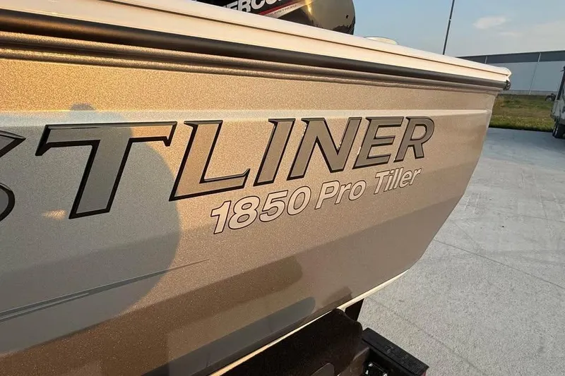 Slide: The Image of 2026 Crestliner 1850 Pro Tiller boat exterior with logo in sunlight. - 15