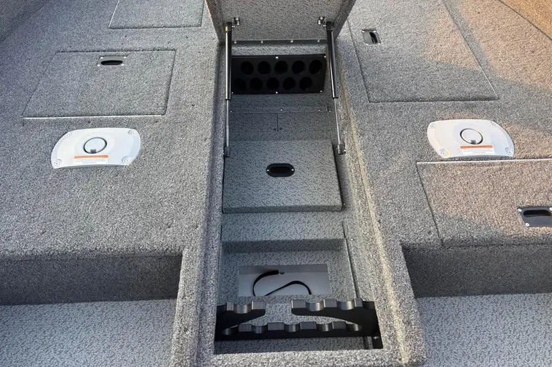 Slide: The Image of 2026 Crestliner 1850 Pro Tiller boat interior with storage compartments and rod holders. - 9